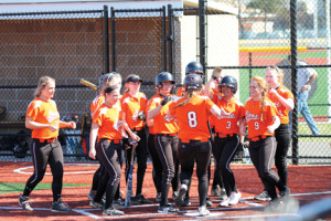 Christine Gebhardt (8) is greeted by her teammates after hitting the first of two three-run homers for the Lions in the top of the third inning.