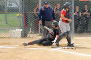Lady Buc Brianna Pennington (24) crosses the plate to score one of the team’s three runs in their 9-3 loss to the Spartans.
