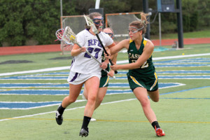  Rumson’s Mary Scarone (27) turns upfield with the ball as Red Bank Catholic’s Amanda Casten (22) reaches in for the check. --Photo by Sean Simmons  