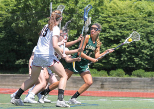 Looking for the shot, Grace Fallon avoids a trio of defenders during a state playoff game against Summit on May 30.
