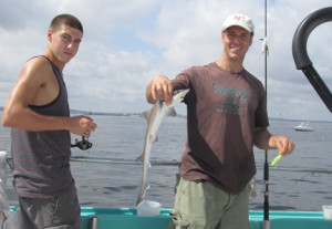 Anthony Fellin of Monroe hauls in a sand shark with the help of his 15-year-old son, Andrew Fellin, as they fish from the deck of the Atlantic Star, a party fishing boat out of Atlantic Highlands. The shark was released back in the water. Photo by John Burton
