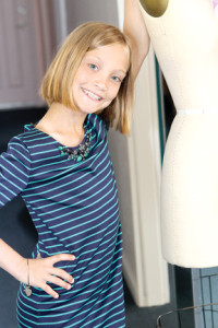 Caroline Durkin is all smiles in this navy and green Monica Gem dress with glittering embellishments at the neckline by Blush By Us Angels at Moon Child in Fair Haven.