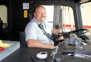 Sandy Hook Fire Chief Frank DeLuca sits behind the wheel of the department's engine.