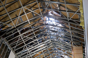 The Holy Cross R.C. Church nave will be covered by a barrel vault and a spire will be placed atop the peaked roof with the sunlight is now shining through. Photo by Michele J. Kuhn