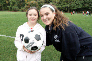 Meghan Vadon and buddy Brianne Naughton take a break from their Challenged Youth Sports soccer game. 