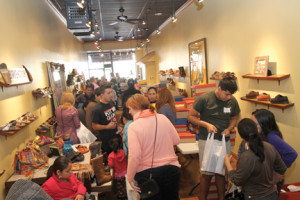 Area resident crowd into the The Doc Shoppe for the free children’s shoe giveaway.  