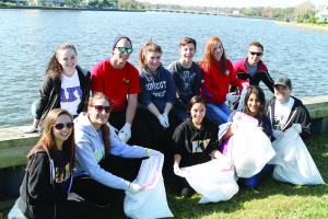 Members of the Alpha Kappa Psi fraternity help clean up Deal Lake as part of Monmouth University's Big Event, a community service project, last Saturday.