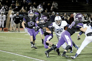 Bryan Hess, No. 28 of RFH, races up the middle for good yardage against Arthur L. Johnson High School in the opening round of the CJ Group 2 playoffs last Friday night. --Sean Simmons