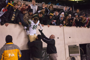 Doug Zockoll, No. 89, gets lowered down from appreciative fans in the stands.