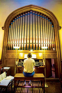 Church organist Tim Broege playing an original Hilborne Roosevelt Organ. Photo Courtesy Rob Seifert