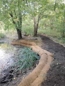 As seen along the edge of Murray Pond, tube-shaped coir logs are used to control erosion. They are filled with biodegradable material. Photo: 