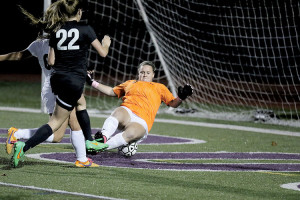 RFH goalie Samantha Beaudreault makes a diving save as Jackson Memorial's Caitlyn Fogarty (22) closes in. Beaudreault turned back nine shots to record the shutout for the Bulldogs. Photo: Sean Simmons