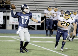 Middletown South quarterback Matt Mosquera (17) drops back to throw a pass as Marlboro linebacker Chris Carbone (28) closes in. Photo by Sean Simmons