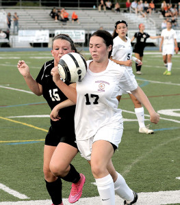 Amanda Glynn (17) of Middletown South and Cali Cook (15) of Middletown North vie for the ball. Photo: Sean Simmons