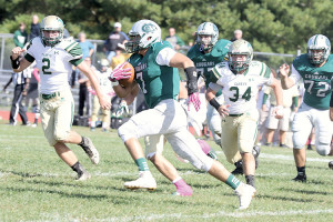 Colts Neck starting quarterback Max Mullaney (7) tries to elude RBC defenders Colin Shaughnessy (2) and Joey Hagan (34). Photo: Sean Simmons