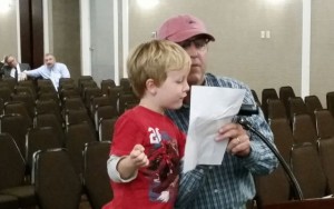 Gavin Malloy, a 5-year-old Middletown resident, and his father, Matt Malloy, express their objections Thursday night to the proposed Port Ambrose liquid natural gas terminal off of Long Branch. Photo: John Burton