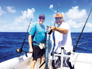 Ray Menz and Capt. Chris shows off another fat barracuda. Courtesy: Karl Meyers