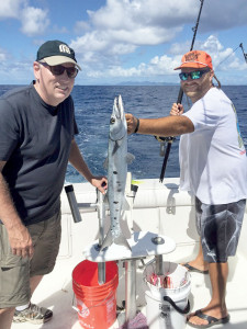 Ray Menz and Capt. Chris shows off another fat barracuda. Photo courtesyRay Menz
