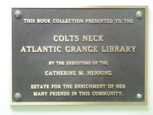 The library plaque for the Catherine "Kitty" Marshall Henning cookbook collection at the Colts Neck Library. 