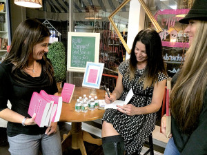 Author Michelle Sassa signs copies of her book “Copygirl,” at a Nov. 19 book launch at River Road books. Photo: Christina Johnson