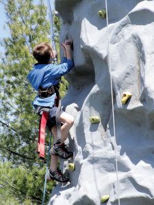 A youngster hits the climbing wall at Holmdel Community Day.