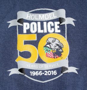 The logo of the 50th anniversary of the Holmdel Police on a sweatshirt.