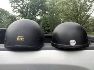A side-by-side comparison of a DOT Certified helmet (left) next to a novelty helmet with a fake DOT sticker on.