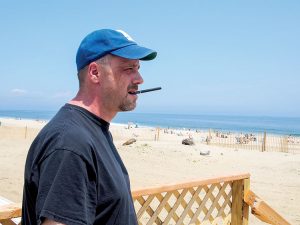 Kyle Worland with an e-cigarette on the boardwalk at Sea Bright Beach. 
