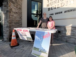 Frances Haies (left) and daughter Sarah next to their information stand outside the Hazlet Township Municipal Building prior to the meeting.