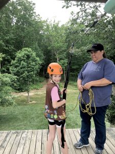Norah Cizin, 9, of Lincroft, prepares to zip-line as part of the Girl Scout crossover ceremony held at Camp Sacajawea in Farmingdale. Photo courtesy of Troop 856. 