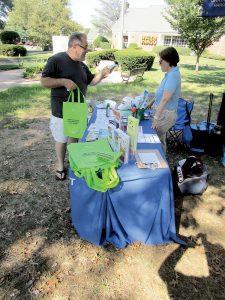 Allen Riso, 62, of Atlantic Highlands stops by a Monmouth County Health Department table providing mosquito information in his town’s Veterans Memorial Park. He talks to Terry Ruane, a senior public health nurse in the health department.