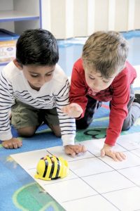 Students in Ranney School’s Age-3 Beginners program use Bee-Bots to move around grids while learning the basics of robotics. 