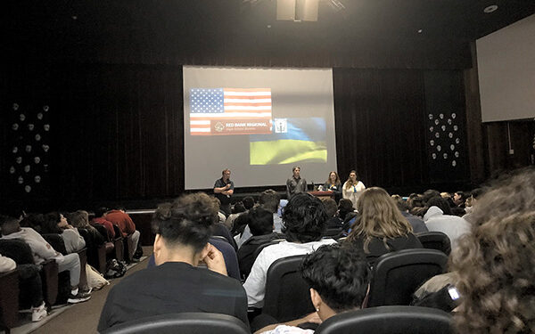 Red Bank Regional High School seniors gathered in the auditorium last Tuesday for a living history lesson on the war in Ukraine presented by David and Natasha Halbout and their niece, Maiia Dvorina, who fled from Ukraine last spring. The presentation was arranged by AP English teacher Andrew Forrest.
