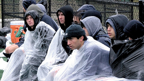 The CBA soccer reserves looked on during a match that saw steady rainfall and windy conditions.