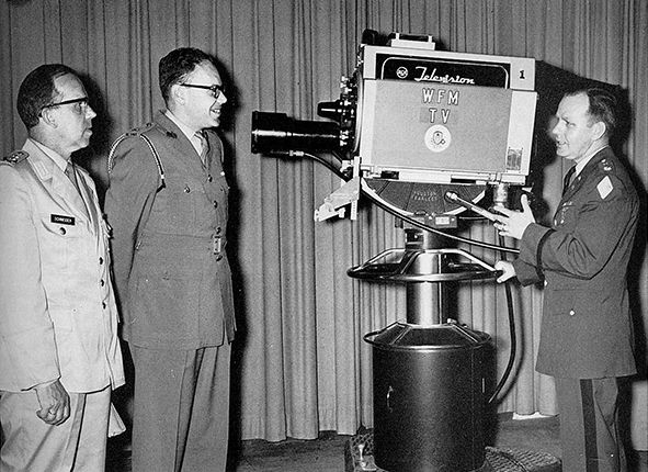 Maj. Frank J. Peterson, chief of the TV division, explains the use of a television camera to German and Canadian liaison officers. Courtesy National Archives 